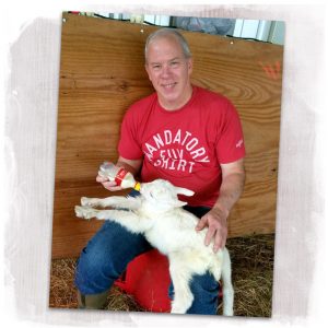 Owner Gary Young feeds a young kid at Dapper Goat Dairy